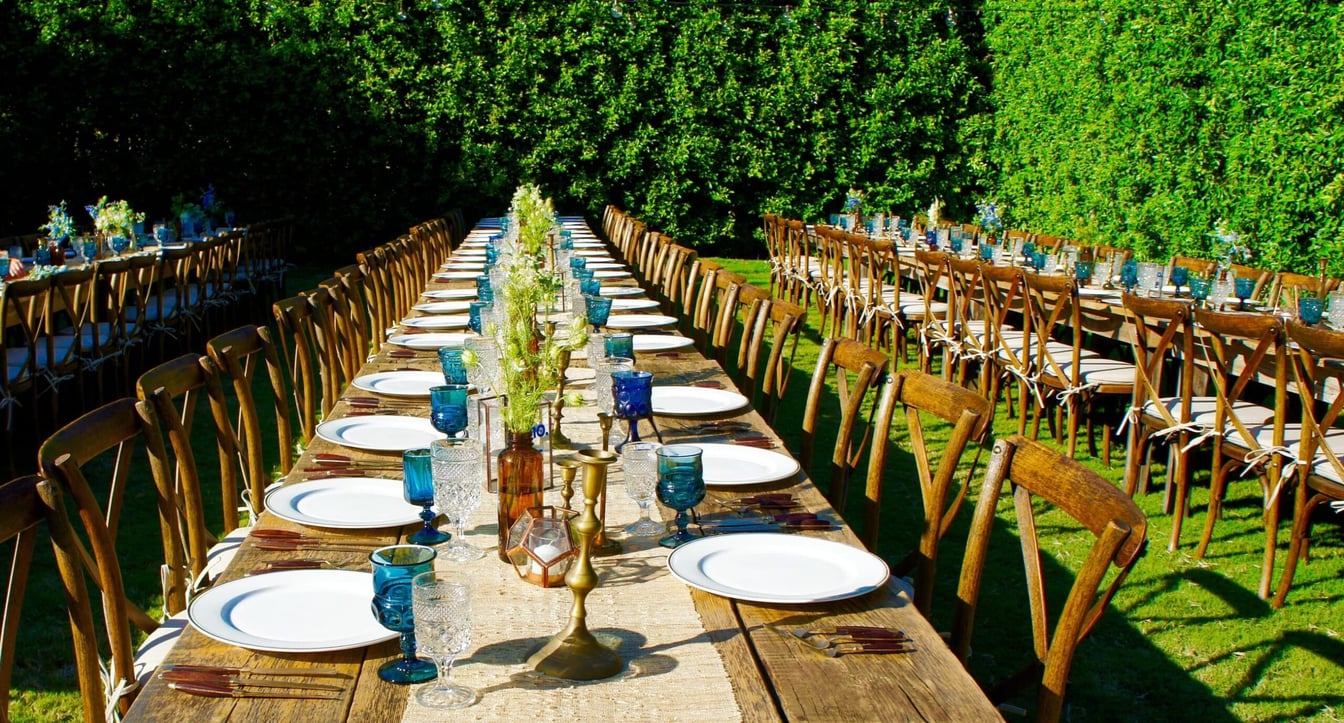 a long table set for a formal outdoor event