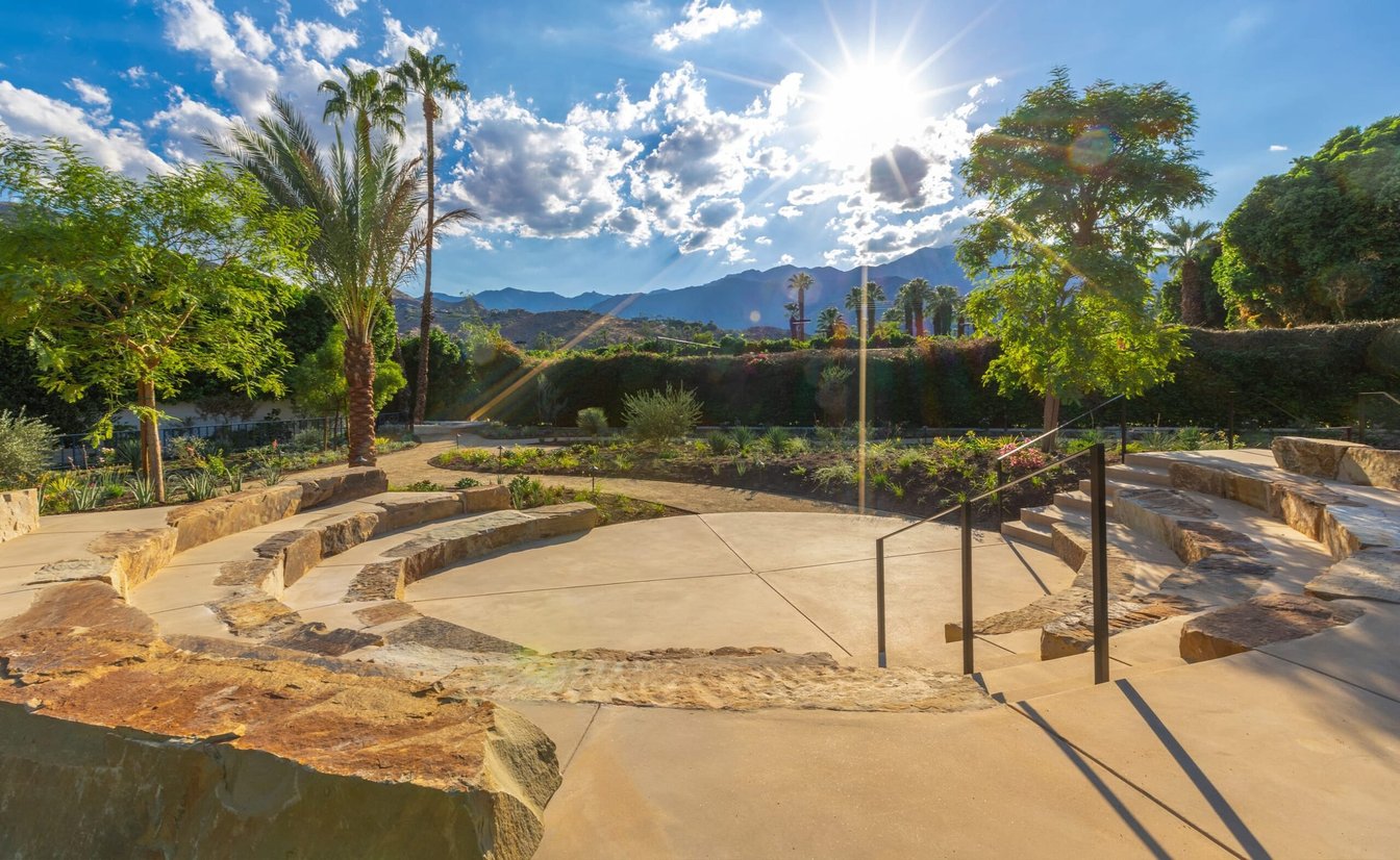 A stone outdoor seating area with a mountain view