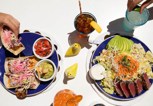 A table setting with two plates of food and drinks