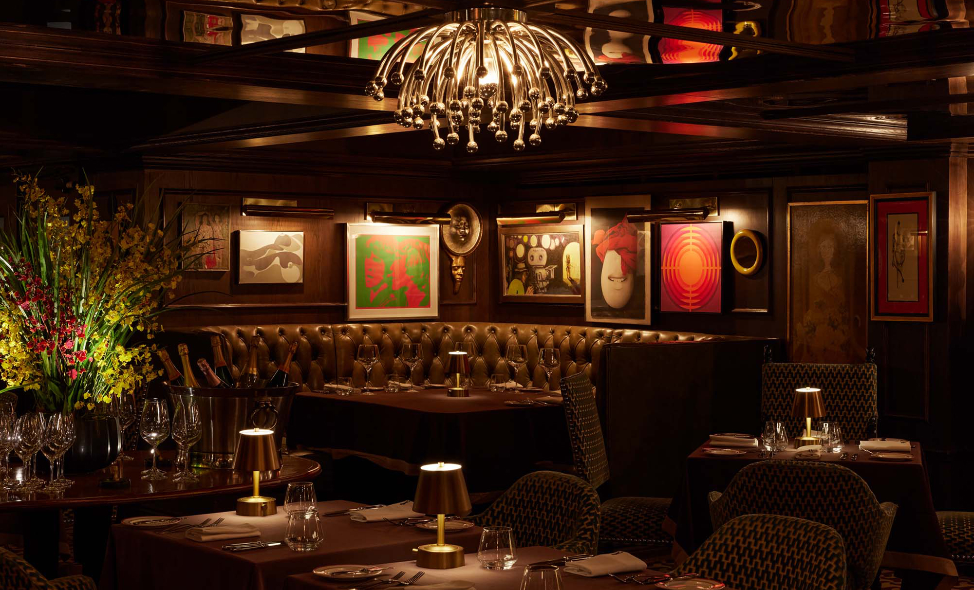 interior view of dimly-lit restaurant with chandelier and dining tables
