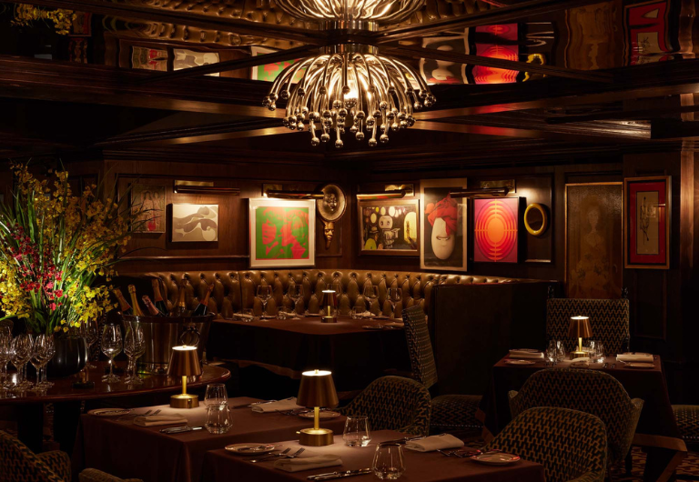 interior view of dimly-lit restaurant with chandelier and dining tables