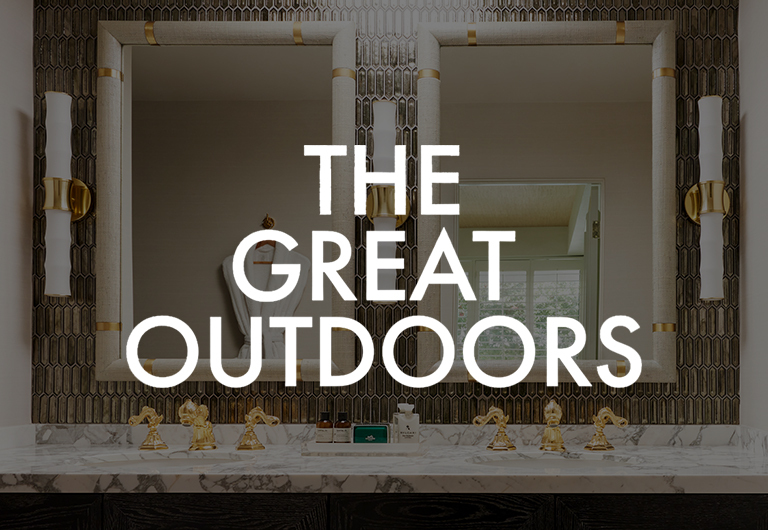 A bathroom sink with gold faucets, marble countertop, and two mirrors. Text over the image reads, THE GREAT OUTDOORS..
