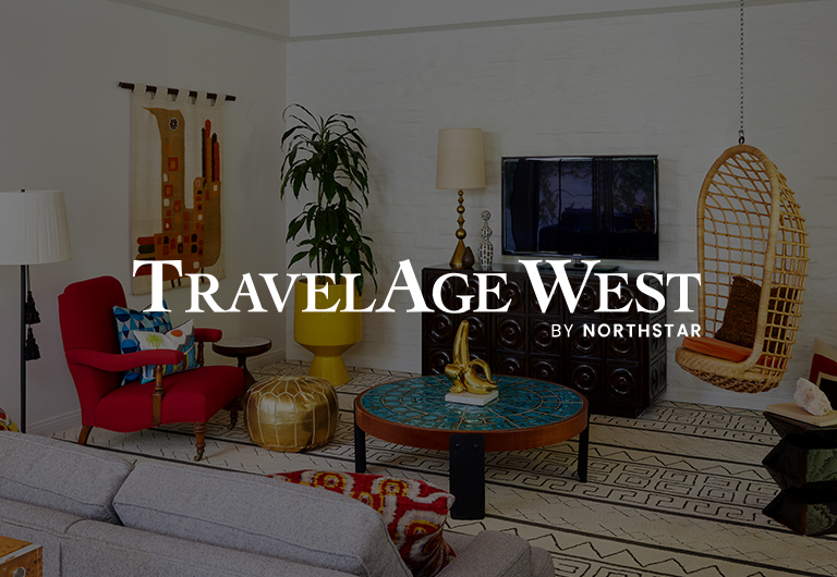 Eclectic living room with vintage and modern decor, wicker chair, red armchair, wall art, patterned rug, and a flat-screen TV. TravelAge West by Northstar text overlay in the center.